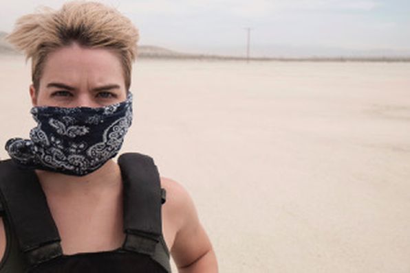 Stephen Ford in desert with bandana over his face